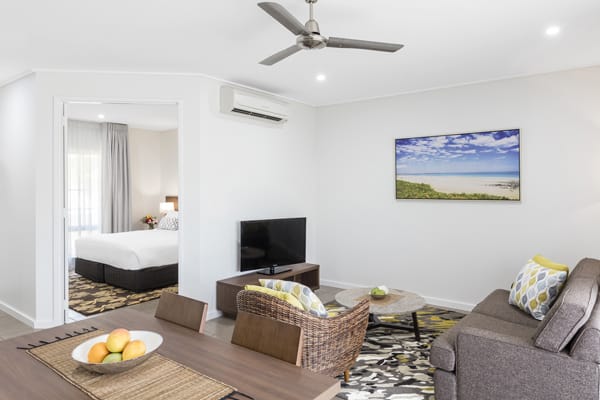 air conditioned hotel accommodation living room with Wi-Fi access, Foxtel on TV, comfortable couches and private balcony outside at Oaks Cable Beach Sanctuary in Broome, Western Australia