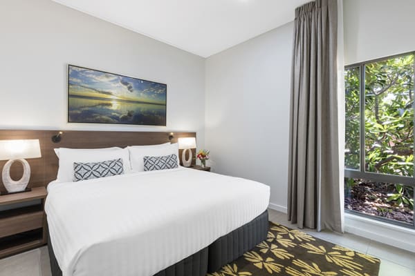 big double bed with clean white sheets and comfortable pillows next to large windows in 3 Bedroom Villa at Oaks Cable Beach Sanctuary hotel in Broome, Western Australia