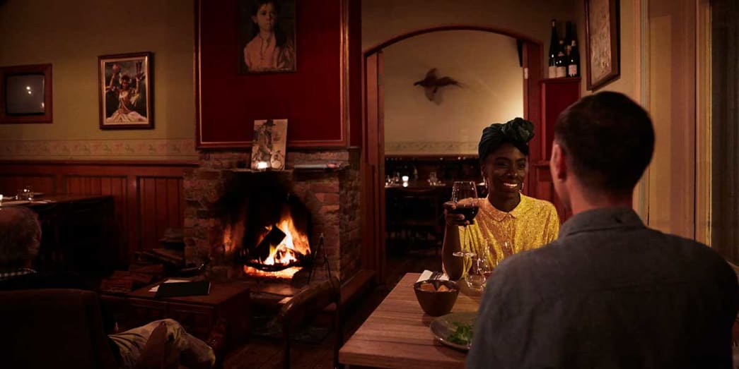 A couple getting cozy in front of a fire at Neighborhood Wine Fitzroy North