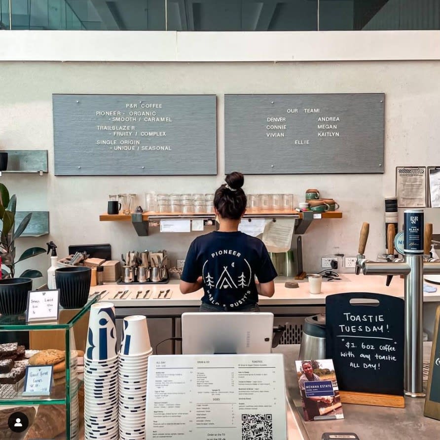 A staff of Pablo Rusty's preparing toasties & coffee specials located at Mary Street in Brisbane