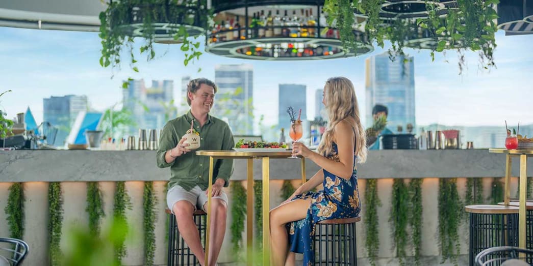Locals enjoying cocktails and snacks at the WET Deck with views of the city centre.