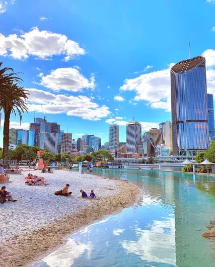 South Bank Parkland's Streets Beach with its aquatic blue waters, city skyline views and golden sandy beach
