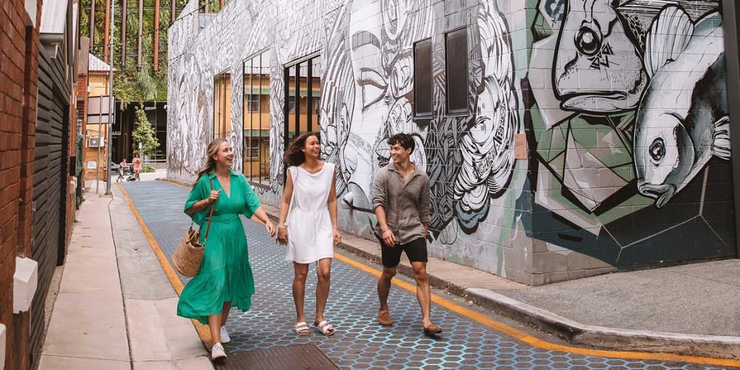 Group of friends walking along the Fish Lane alley to spot bounty of bars, restaurants, cafes, art galleries and entertainments
