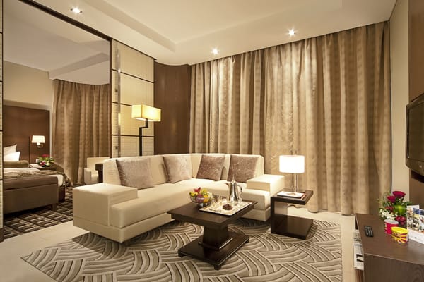 big living room of Deluxe Superior Suite hotel apartment with TV, Wi-Fi and air conditioning at Oaks Liwa Executive Suites in Abu Dhabi city centre in United Arab Emirates