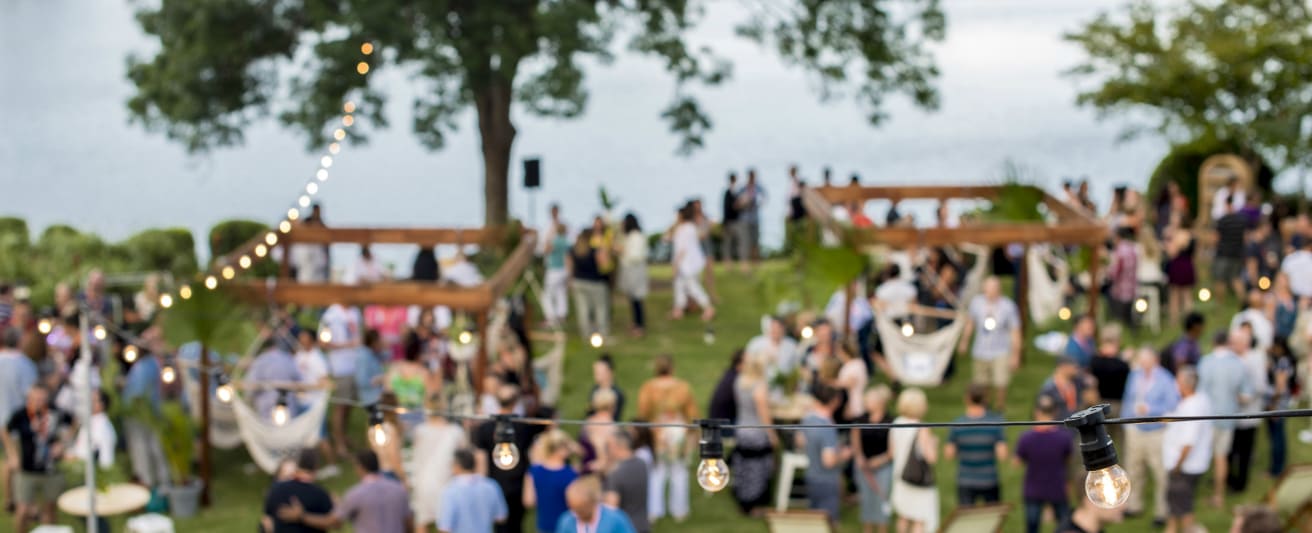 event venue in hunter valley with people outside near river eating food