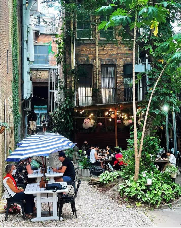 At the courtyard of Coffee Iconic Shop, with customers drinking coffee