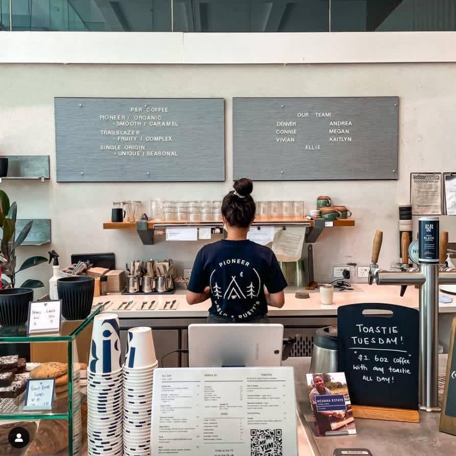 A staff of Pablo Rusty's preparing toasties & coffee specials located at Mary Street in Brisbane