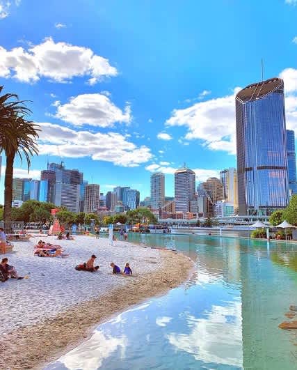 South Bank Parkland's Streets Beach with its aquatic blue waters, city skyline views and golden sandy beach