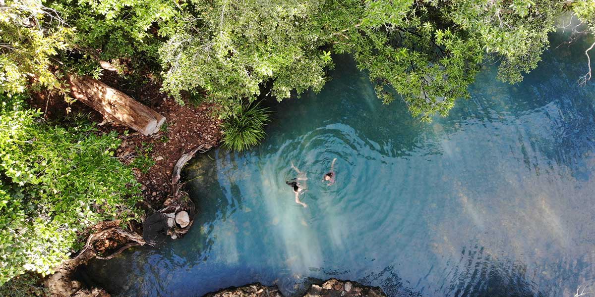 Cardwell Spa Pool, a naturally-fed seasonal creek famous for its idyllic blue waters.