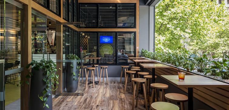 balcony with bar stools and tables at popular Oak and Vine restaurant on Market Street, Melbourne CBD, Victoria, Australia