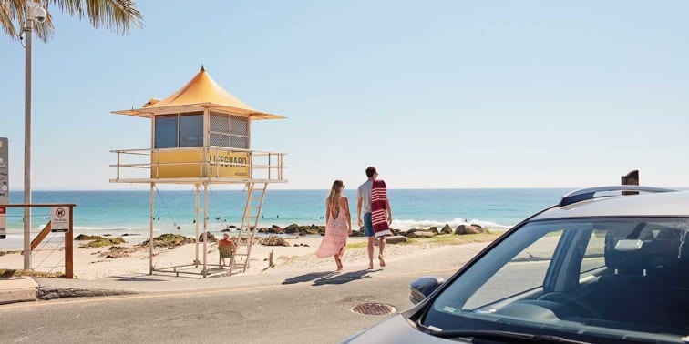 Couple walking by the beachside of Coolangatta, Gold Coast
