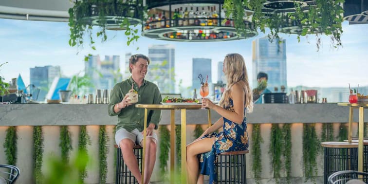 Locals enjoying cocktails and snacks at the WET Deck with views of the city centre.