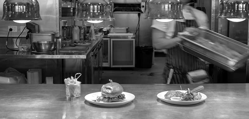 staff preparing Burger at the kitchen of The Restaurant Oaks Cypress Lakes Resort