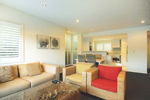 lounge area with comfortable couches in 1 bedroom hotel apartment nelson bay new south wales nsw