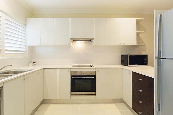kitchen with full size fridge oven and microwave in air conditioned hotel apartment port stephens nsw