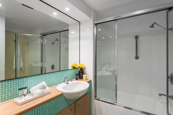 en suite bathroom with shower at oaks waterfront resort hotel