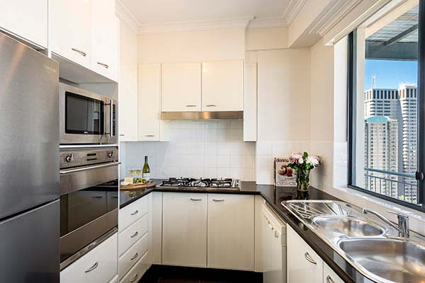 3 bedroom apartment kitchen with oven, microwave, cook top and full-size fridge in Sydney city centre