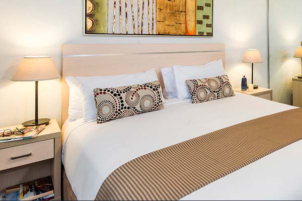 studio hotel accommodation in Sydney with queen-size bed, large wardrobe and full length mirror for guests