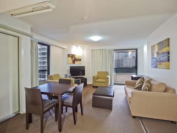 living room in 1 bedroom apartment at Oaks Hyde Park Plaza with balcony and views of Sydney CBD