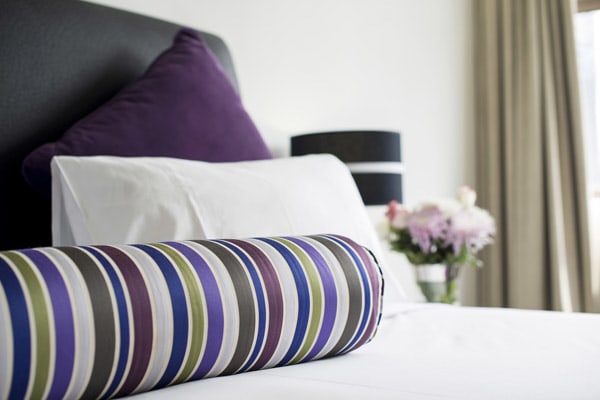 close-up image of pillows on bed in 1 bedroom executive apartment at Oaks Hyde Park Plaza hotel in Sydney