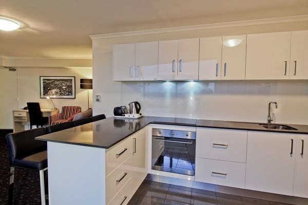 open plan kitchen in 2 bedroom 4 star apartment at Oaks Hyde Park Plaza hotel in Sydney city