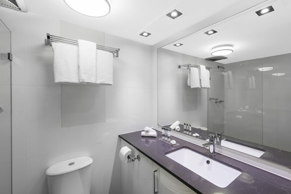 modern en suite bathroom in 2 bedroom hotel apartment at Oaks Hyde Park Plaza, Sydney