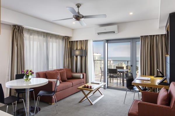 hotels Darwin with comfortable couches and large flat screen television in 1 bedroom hotel apartment at Oaks Elan Darwin