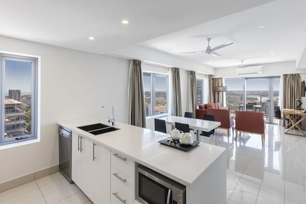 open plan kitchen and living room in 2 bed hotel apartment with microwave and ceiling fan at Oaks Elan Darwin