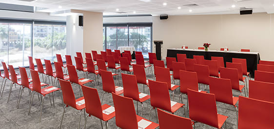 large conference room set-up for speaker with rows of chairs, sound system and microphone in Darwin NT