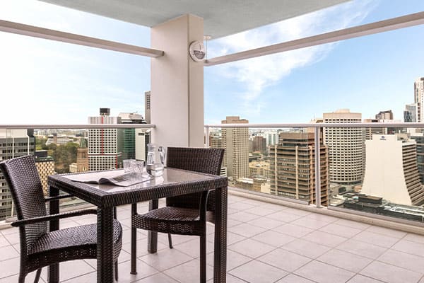 1 bedroom apartment balcony with table and chairs and view of Brisbane River at Oaks Casino Towers hotel