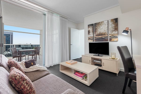 spacious living room connected to a balcony at Oaks Brisbane Casino Tower Suites 1 Bedroom Apartment 