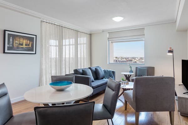 large living room area with comfortable couches with nice city view in 2 bed Brisbane hotel apartment