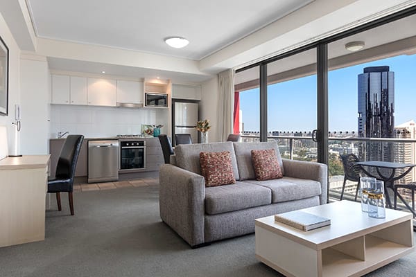 Oaks Brisbane Felix Suites 1 Bed Apartment Living space and open kitchen attached to a spacious balcony with nice city view 