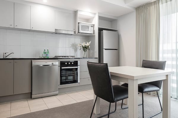 kitchen area in 1 bedroom apartment with large refrigerator and oven at Oaks Felix hotel Brisbane city centre
