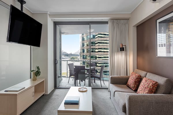 Living Room next to a balcony with city view at Oaks Brisbane on Felix Suites 1 Bedroom Executive 