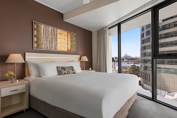 Oaks Brisbane Felix Suites 2 Bed Apartment Bedroom with king sized bed and nice view and story bridge and Brisbane river 
