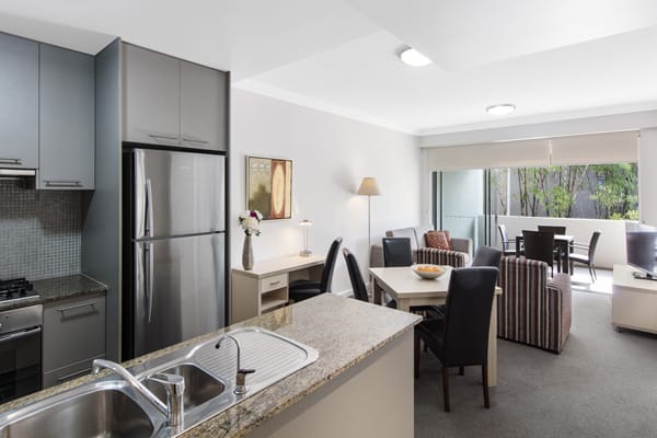 living room area with comfortable furniture in 1 bedroom apartment at Oaks Mews hotel near Royal Brisbane Womens Hospital