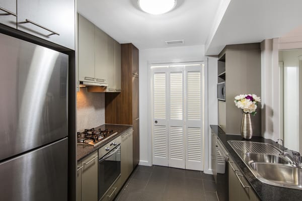 2 bedroom apartment kitchen with large fridge, oven, microwave and stove top near TAFE Bowen Hills