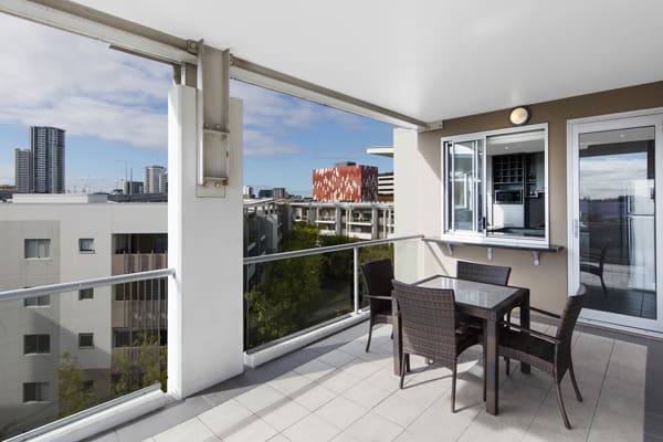 Bowen Hills Hotels large 3 bedroom apartment balcony with tables and chairs on Campbell Street in Bowen Hills Brisbane