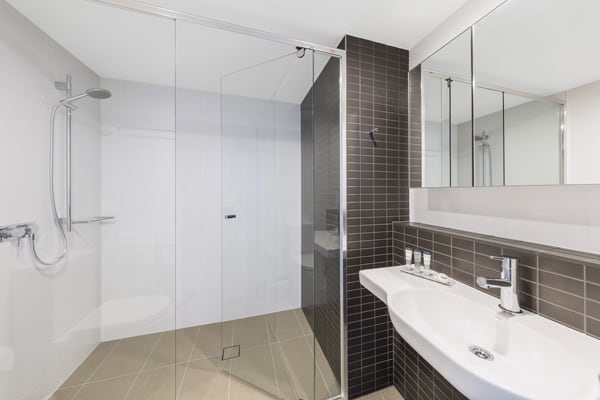 large shower with adjustable shower head in en suite bathroom of 2 bedroom executive apartment at The Milton Brisbane hotel