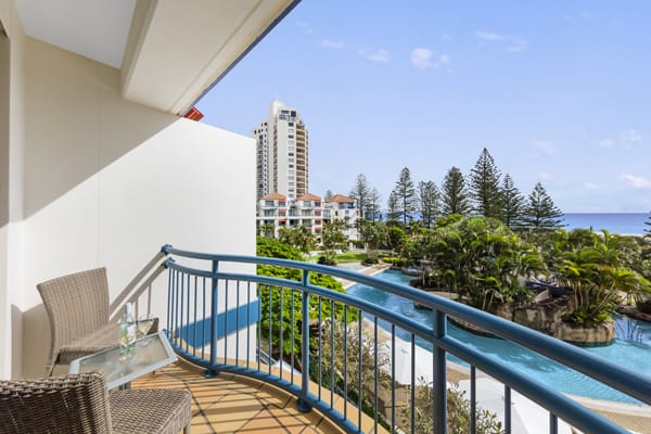 view from 1 bedroom apartment balcony of the ocean and swimming pool at Oaks Calypso Plaza hotel resort on Gold Coast, Australia