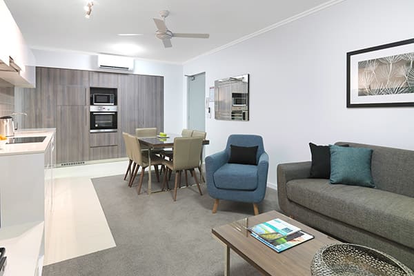 air conditioned living room in two bedroom apartment at affordable hotel in Mackay with comfortable furniture