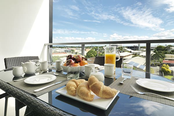 healthy hotel breakfast on balcony of three bedroom apartment at Oaks Mackay hotels with wi-fi at Oaks Carlyle hotel