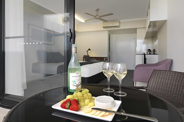 Best hotels Mackay with wine, cheese and biscuits on table on balcony of hotel room at Oaks Carlyle in Mackay, QLD