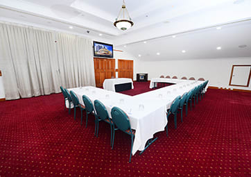 Rockerfeller conference room set for event at Oaks Grand Gladstone hotel in Queensland with whiteboard and air con