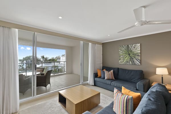 Comfortable lounge room of 1 Bedroom Ocean View hotel room at Oaks Hervey Bay resort