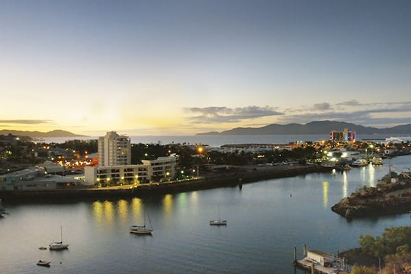 view of Ross Creek and Townsville Harbour at sunset from balcony of studio apartment at Oaks M on Palmer hotel in Townsville