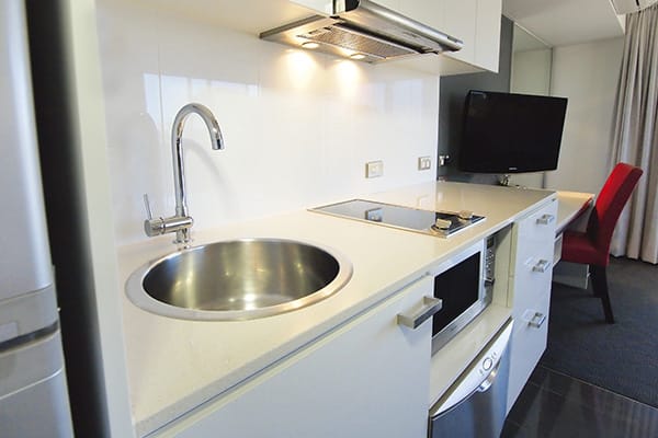 kitchenette with microwave and small fridge in studio hotel apartment near Jupiters Casino in Townsville