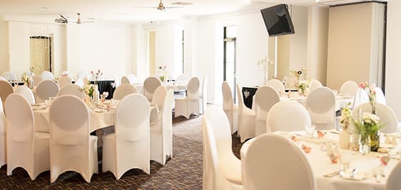 Guests in Oaks Metropole Hotel wedding venues Townsville ballroom with bride and groom