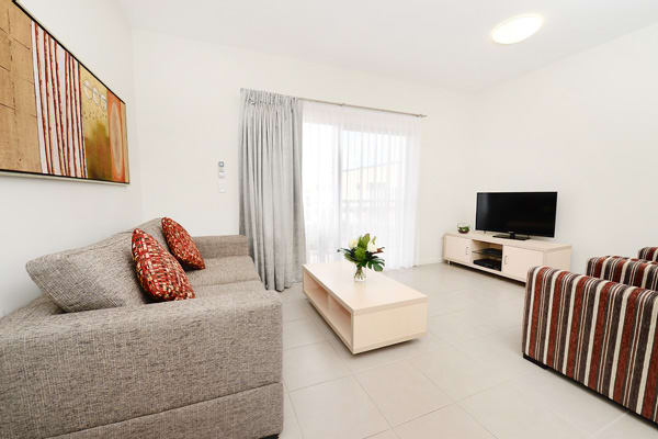 living room with TV, Foxtel, Wi-Fi and private balcony at Oaks Middlemount hotel near airport
